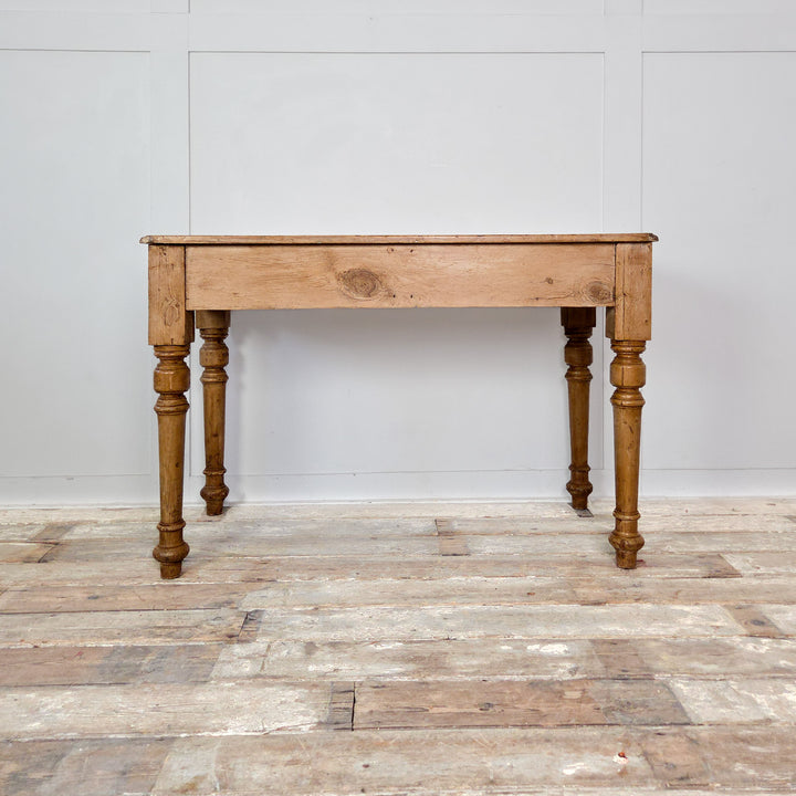 Antique pine console table from the 19th century with decorative turned legs, wooden knobs and a honey-toned waxed surface. A rustic piece suited to hallway or living spaces.