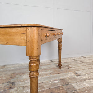 A 19th-century pine console or writing table standing on turned legs with twin drawers. Finished in wax to protect the timber, suitable for farmhouse and country homes.