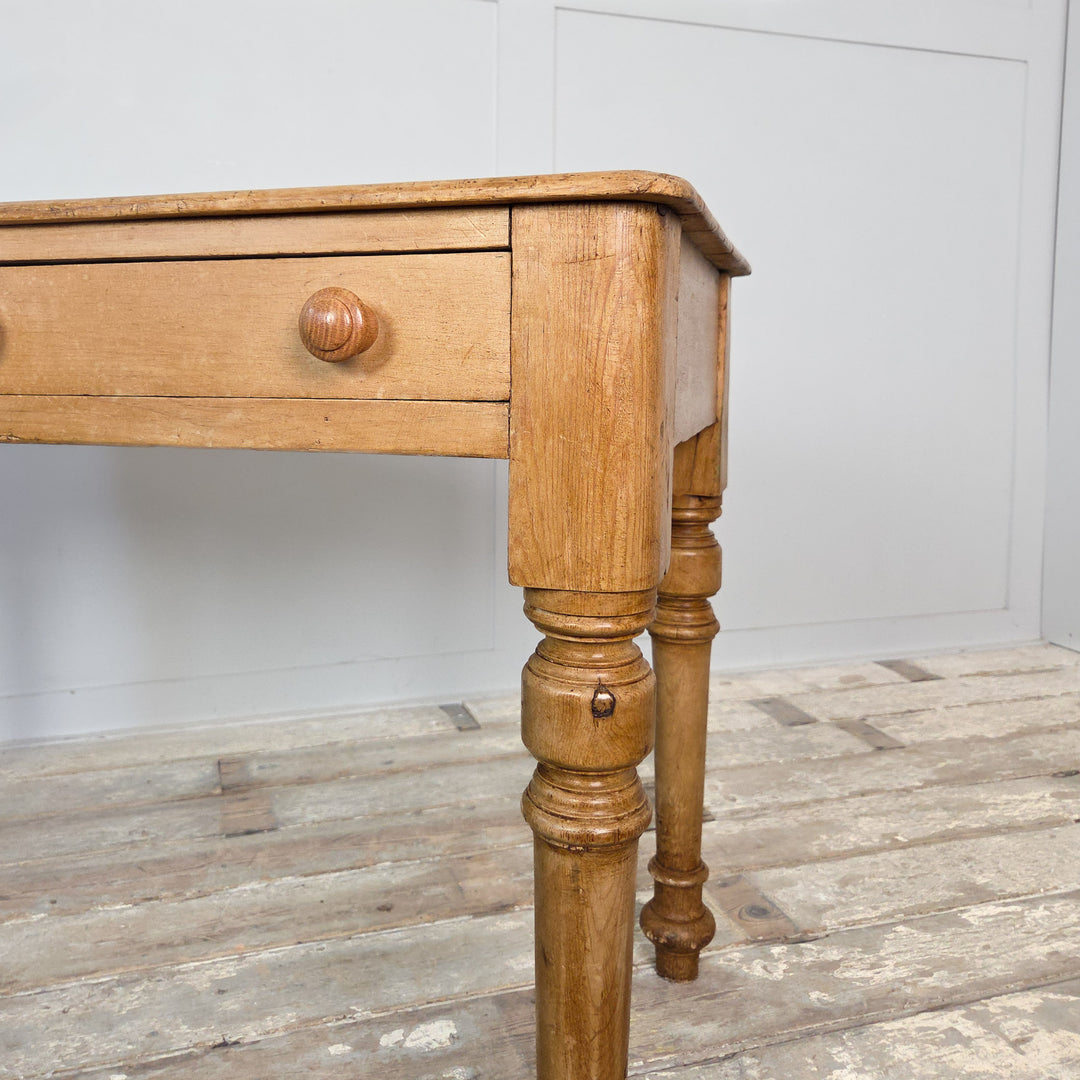 19th-century pine console table with two drawers, turned legs and plain apron, sealed in wax to preserve the wood. A versatile antique for country or farmhouse settings.
