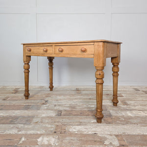 Antique 19th-century pine console or dressing table with waxed surface, turned legs and two drawers with wooden knobs. Ideal for rustic, farmhouse or country décor.