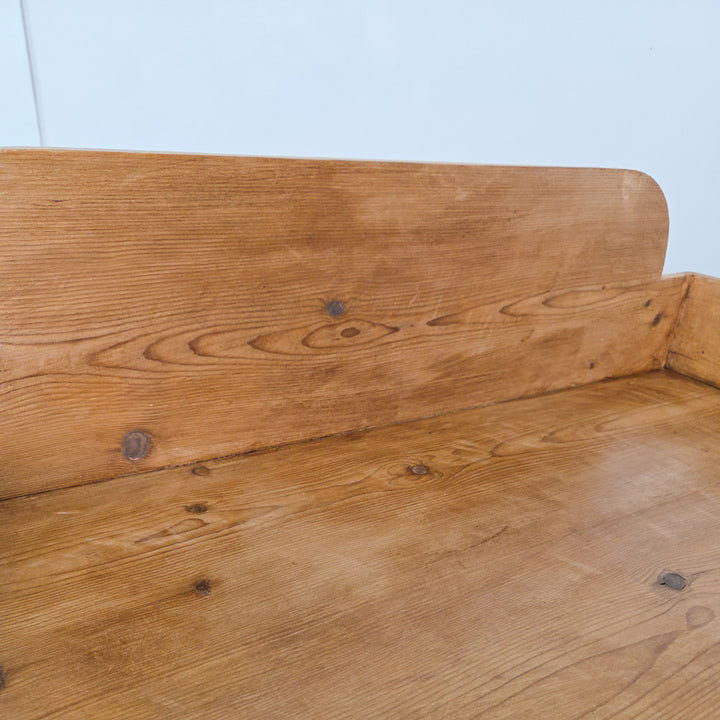 A 19th-century pine washstand with shaped gallery back and turned legs, finished in wax to seal and highlight the original patina. A practical Victorian piece suited to rustic, country and farmhouse style homes.