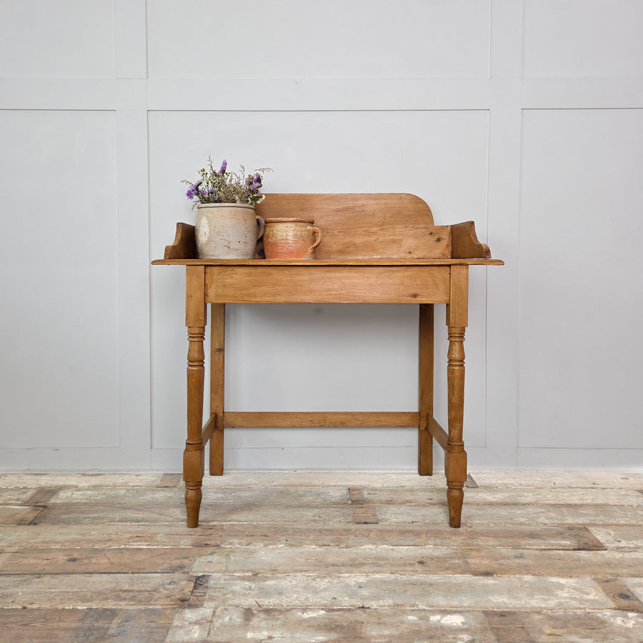 19th-century Victorian pine washstand with raised gallery back and turned legs, sealed with wax to protect the wood. A charming and functional antique in rustic country or farmhouse style, perfect as a side or dressing table.