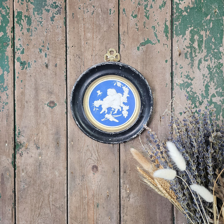 Vintage cherub wall roundel with gold trim.
