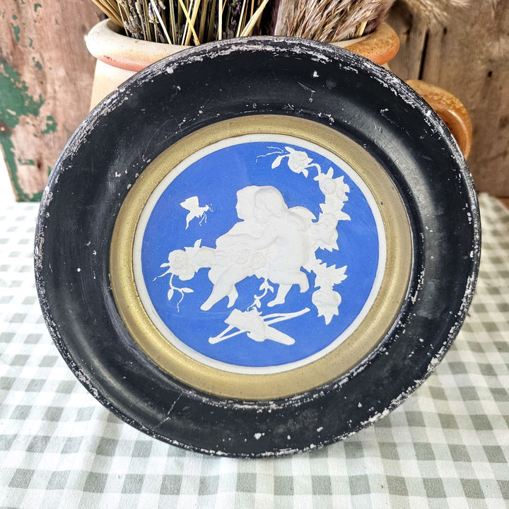 Hanging wall art with cherub design in plaster.
