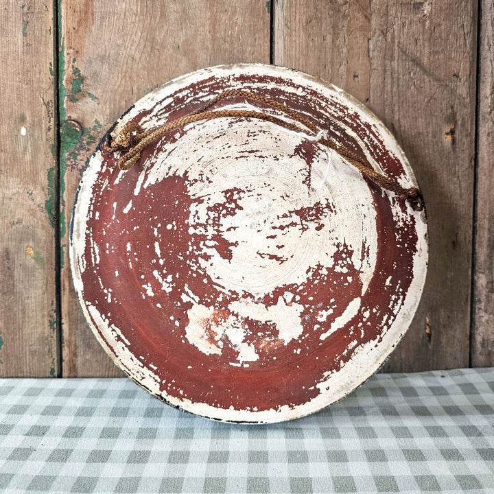 Round cherub plaque for home decor.
