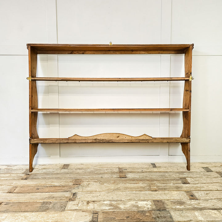 Victorian pine wall-mounted shelf with cup storage.