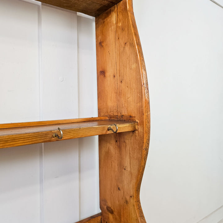 19th-century wall rack with three storage shelves.