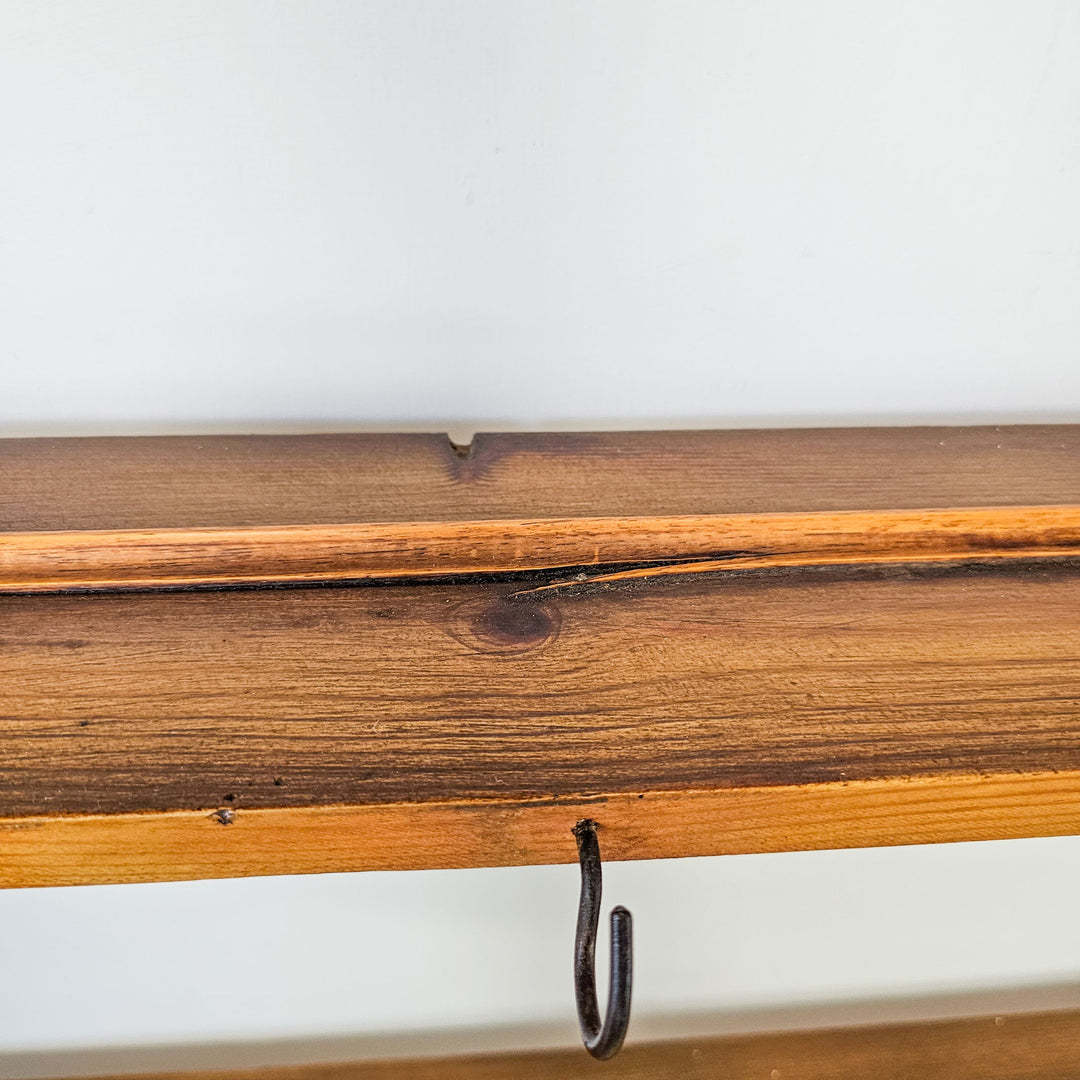 Antique kitchen wall rack with shelves and hooks.