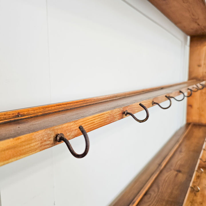 Victorian pine wall rack mounted above a countertop.