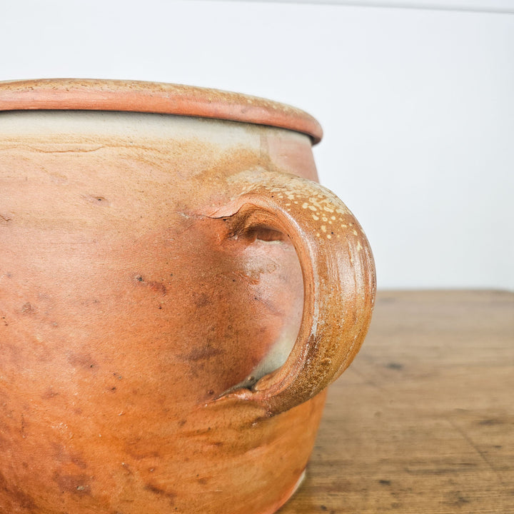 Rustic antique rillette or confit pot with handle and soft glazed finish from France.