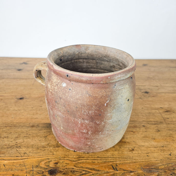 Rustic antique rillette or confit pot with handle and soft glazed finish from France.