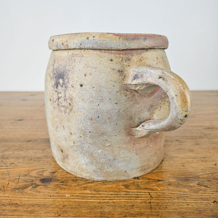 Decorative antique confit pot with a handle, ideal for home décor.