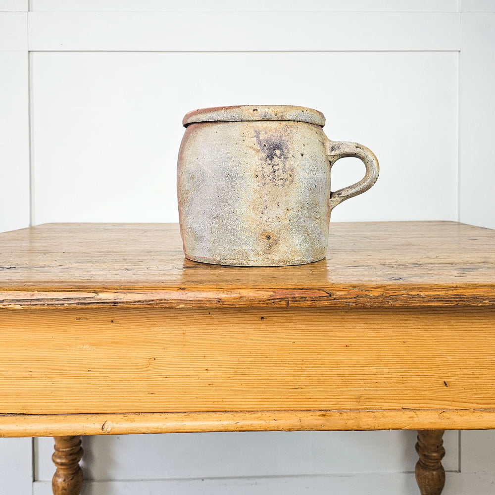 Antique French rillette pot with a rustic charm and soft glaze.