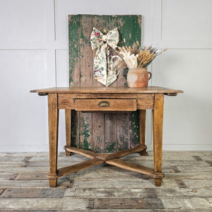 "French fruitwood table with planked top and single drawer."