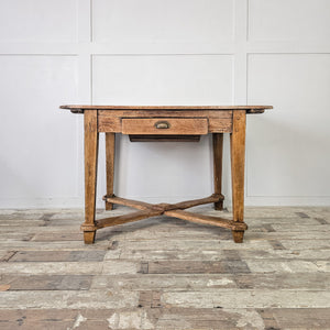 "Antique table with natural patina and robust legs."
