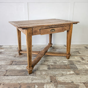 "French provincial table with functional drawer and stretcher."
