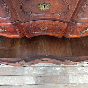 Antique French walnut serpentine commode, 19th century. Designed with four carved drawers, ornate brass handles, and escutcheons. Constructed in walnut, the chest is supported on carved feet and finished with a naturally rich aged patina.