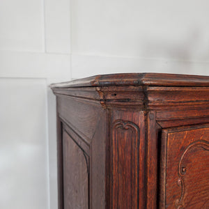 19th century French walnut serpentine commode. Features four full-width drawers with carved fronts, brass handles, and escutcheons. The walnut has developed an attractive patina, and the piece is raised on short carved legs of simple design.
