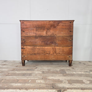 An antique 19th century French walnut serpentine chest of drawers. The piece offers four carved drawers, ornate brass handles, and escutcheons, with shaped fronts and short carved feet. Walnut surfaces have developed a naturally rich patina