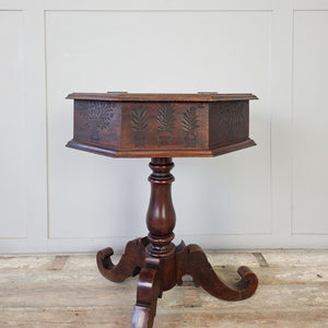 Antique oak occasional table with hinged octagonal lid and turned baluster column