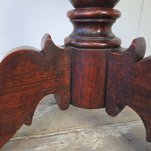 Victorian oak sewing table with decorative carving and interior storage compartment
