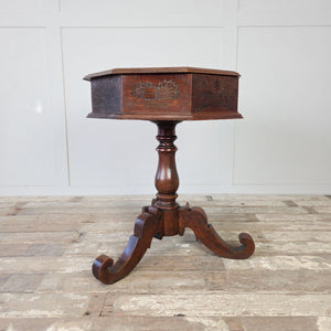 Victorian oak side table with octagonal hinged lid, carved panels and tripod base
