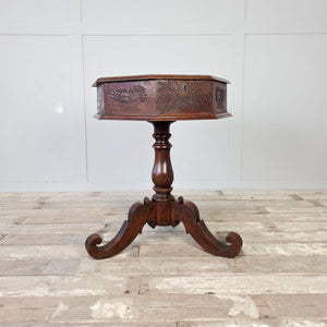 Antique oak sewing table with carved baskets of fruit and laurel sprays to side panels
