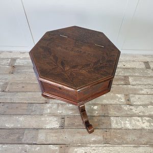 Antique oak side table with octagonal top, hinged lid and turned baluster column on tripod base