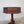 Antique oak occasional table with decorative carved motifs and tripod scrolled leg base
