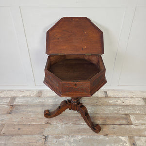 Farmhouse style antique oak side table with octagonal top and decorative carved motifs
