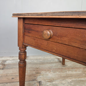 Country pine farmhouse table with rustic stripped pine top, rounded edges, and traditional turned legs. This antique Victorian table features a single drawer with wooden knob and is the perfect size for a smaller kitchen or dining room, or as a functional hall side table.