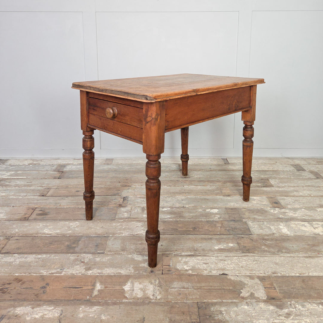 19th century antique pine farmhouse table with rustic stripped top and turned legs, fitted with a single drawer for storage. A charming Victorian country pine table that works well in farmhouse kitchens, dining rooms, or as a side table in a hallway or living space.