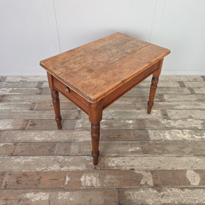 Rustic Victorian farmhouse table in pine with stripped top and softly rounded edges, standing on decorative turned legs. With its compact size and fitted drawer, this 19th century table makes a practical country pine side table, small kitchen table, or antique hall table.