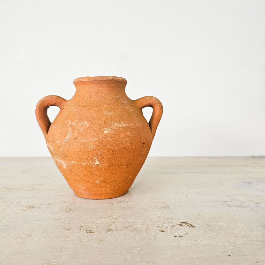 Handmade Turkish terracotta pot with rustic patina and small handles.