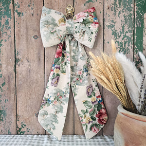 Artisanal bow featuring detailed floral design on soft fabric