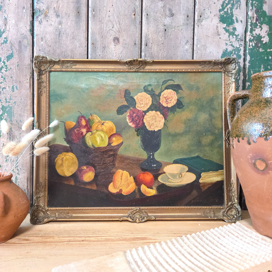 A Victorian still life oil painting on canvas featuring a vase of pale pink and cream roses with fruit and tableware, framed in an ornate gilt frame and signed "G Lance 1876" in the lower right corner.
