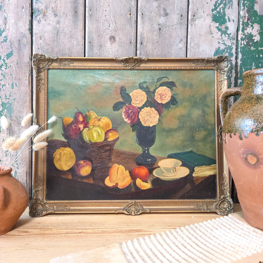A Victorian still life oil painting on canvas featuring a vase of pale pink and cream roses with fruit and tableware, framed in an ornate gilt frame and signed "G Lance 1876" in the lower right corner.
