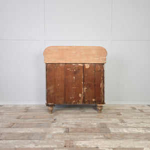 A 19th century Victorian pine chest of drawers featuring four drawers in a two-over-two formation. Decorative brass handles are fitted throughout, and the chest has a shaped gallery back and stands on tulip bun feet.