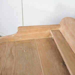 A country-style antique pine chest of drawers dating to the Victorian era, featuring four drawers with decorative brass handles. The chest has a shaped gallery back and stands on turned tulip bun feet.
