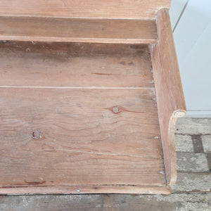 An antique Victorian pine chest of drawers with four drawers arranged in a two-over-two layout and fitted with decorative brass handles. The piece features a shaped gallery back and is raised on tulip bun feet.