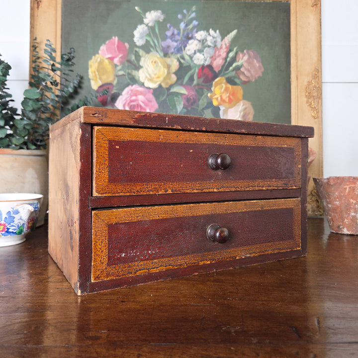 A pair of antique pine drawers from the Victorian period, retaining their original painted finish. The rich warm tones suit rustic decor or country house style settings.