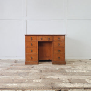 Late 19th century cherrywood writing desk with three drawers across the top and three down each side
