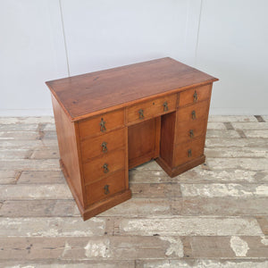Late 19th century kneehole desk in cherrywood with brass drop pendant handles throughout