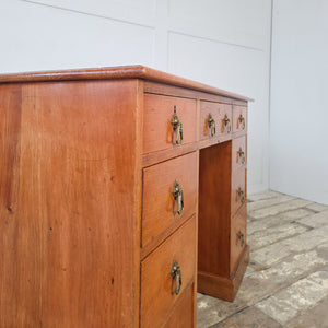 Antique nine drawer kneehole desk in cherrywood with original brass Aesthetic Movement hardware
