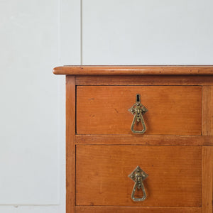 Antique cherrywood desk with a central kneehole cupboard opening to reveal an internal shelf
