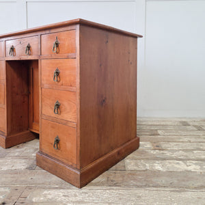 Antique writing desk in cherrywood with nine drawers and a central cupboard with internal shelf