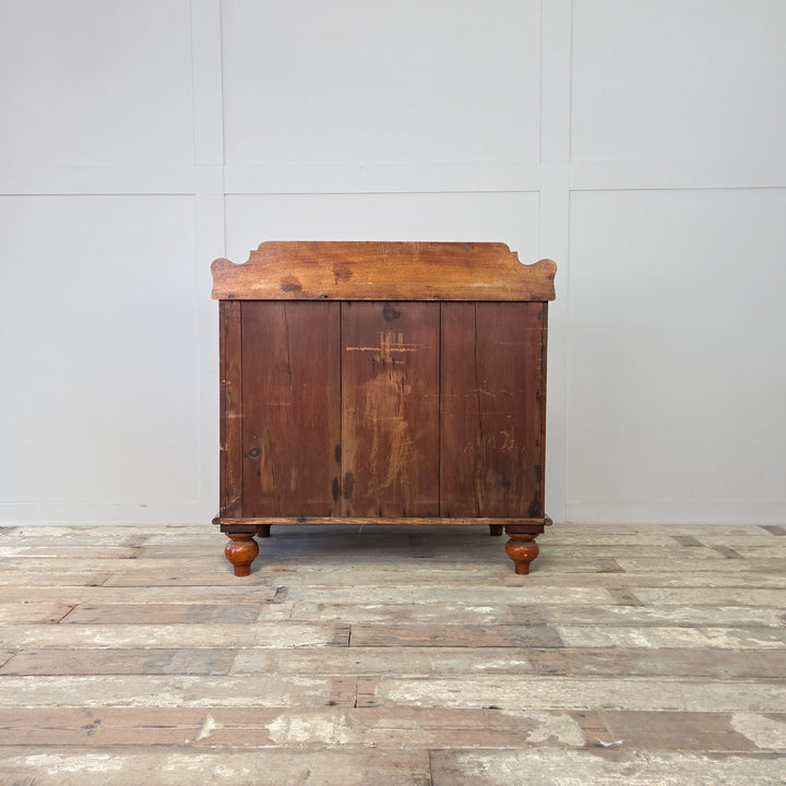 Antique Victorian mahogany chest of drawers, arranged as two short over two long, with original glass knobs, shaped upstand, bun feet and a deep bottom drawer, a four drawer chest of good proportions and practical use, perfect as 19th century bedroom drawers or an antique storage piece for hallways.