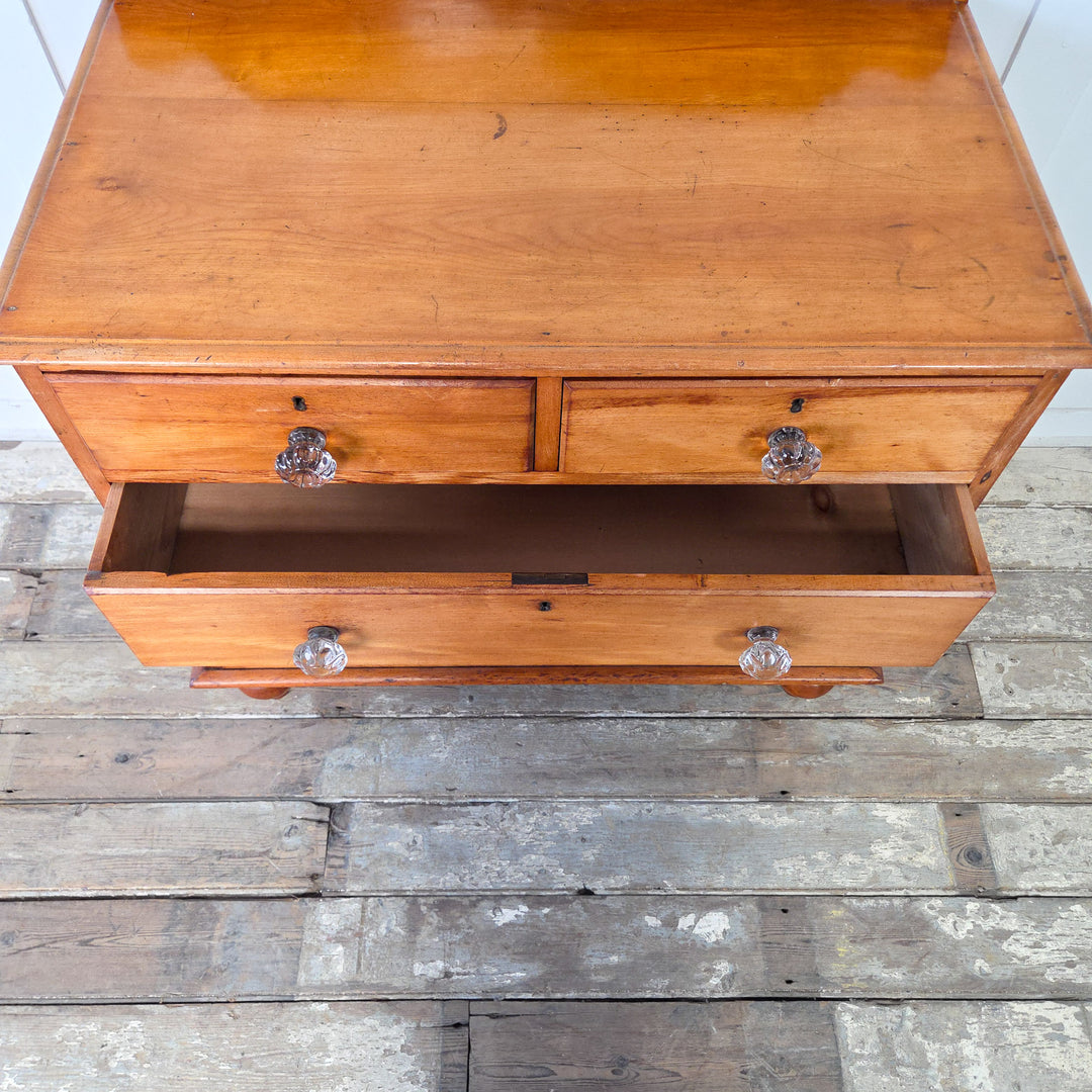 Antique Victorian chest of drawers in mahogany with four drawers, two short over two long, retaining original glass knobs, with a simple top and shaped upstand, standing on bun feet, a 19th century four drawer chest that remains practical and robust, perfect for bedroom drawers or general storage.
