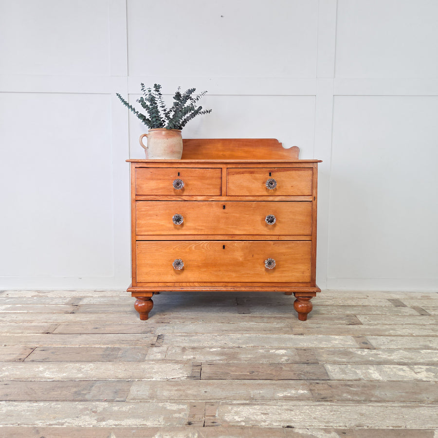 Antique Victorian mahogany chest of drawers, four graduated drawers arranged as two short over two long, with original glass knobs, shaped upstand and bun feet, a versatile 19th century four drawer chest that remains practical and well-made, offering storage for bedrooms, hallways or living spaces.
