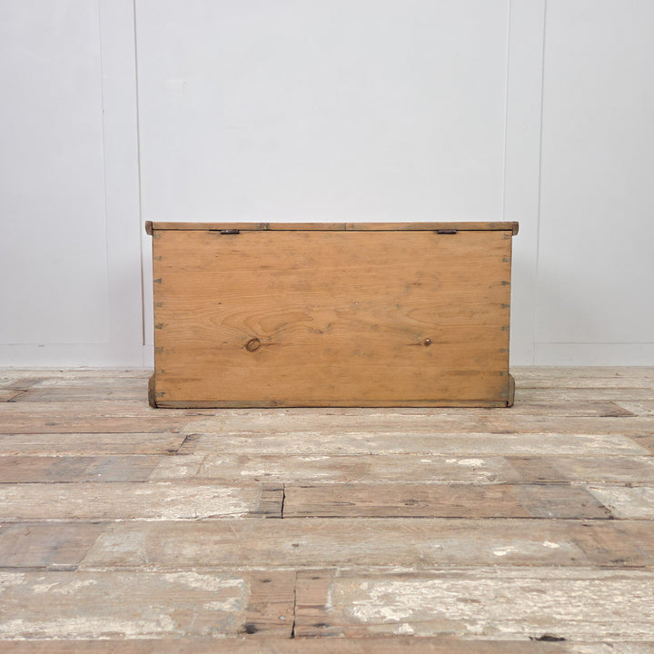 Antique Victorian pine blanket chest crafted from solid pine with hinged lid and two small internal drawers. Finished in clear wax, this rustic storage chest doubles as a farmhouse blanket box or antique trunk with useful enclosed storage.